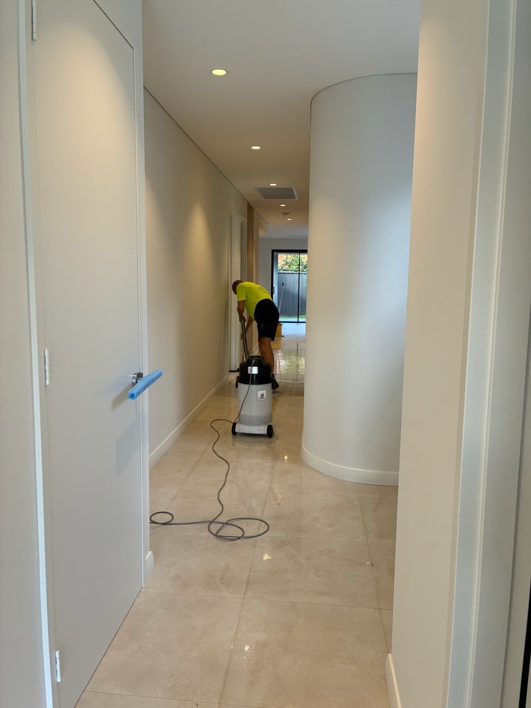 WOCS cleaner using floor equipment in a hallway